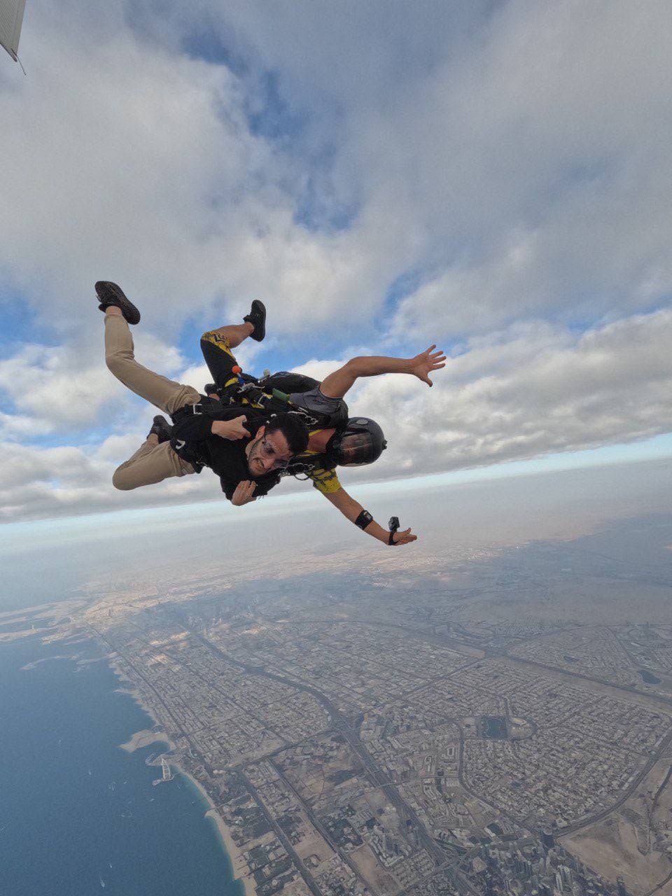 Khalid mid-freefall on a tandem skydive over the coast
